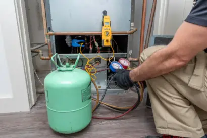 Technician recharging AC gas and fixing leaks